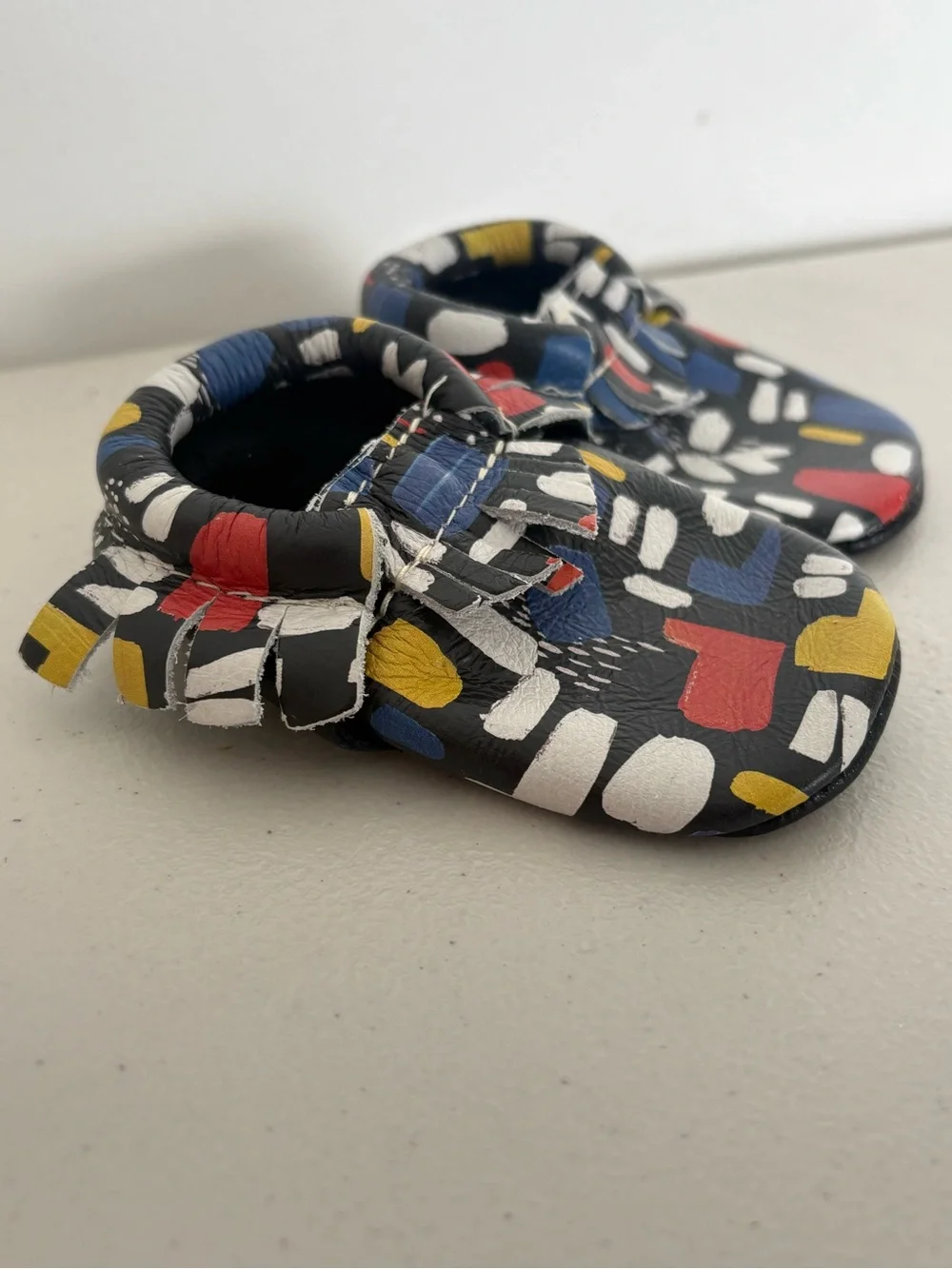 Freshly Picked Black Moccasins with Red, Blue & Yellow Abstract Print